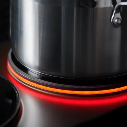 A pot on a burner ringed in orange light