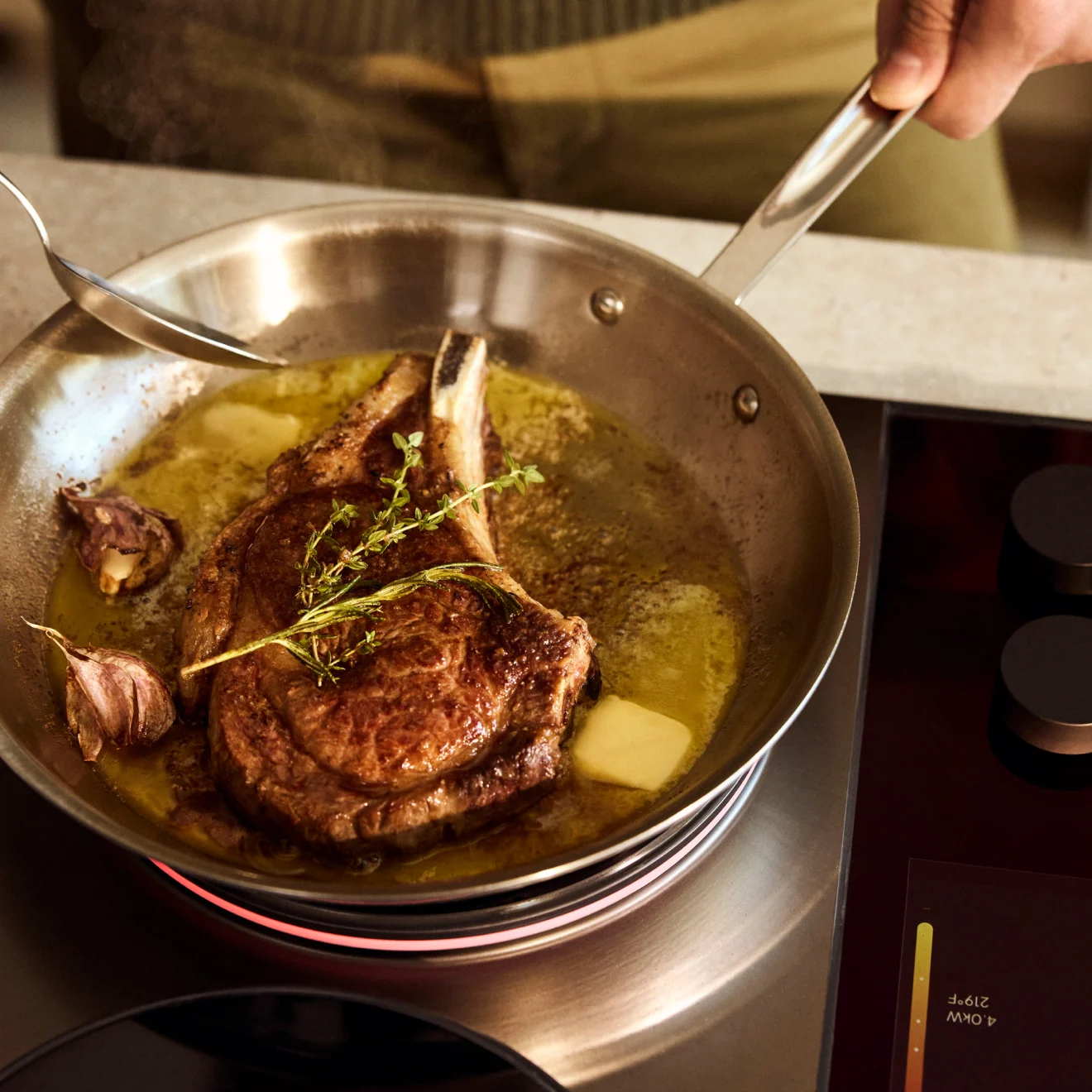 A steak basted in butter on the Impulse Cooktop