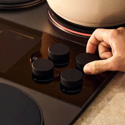 A hand turning one of the magnetic knobs
